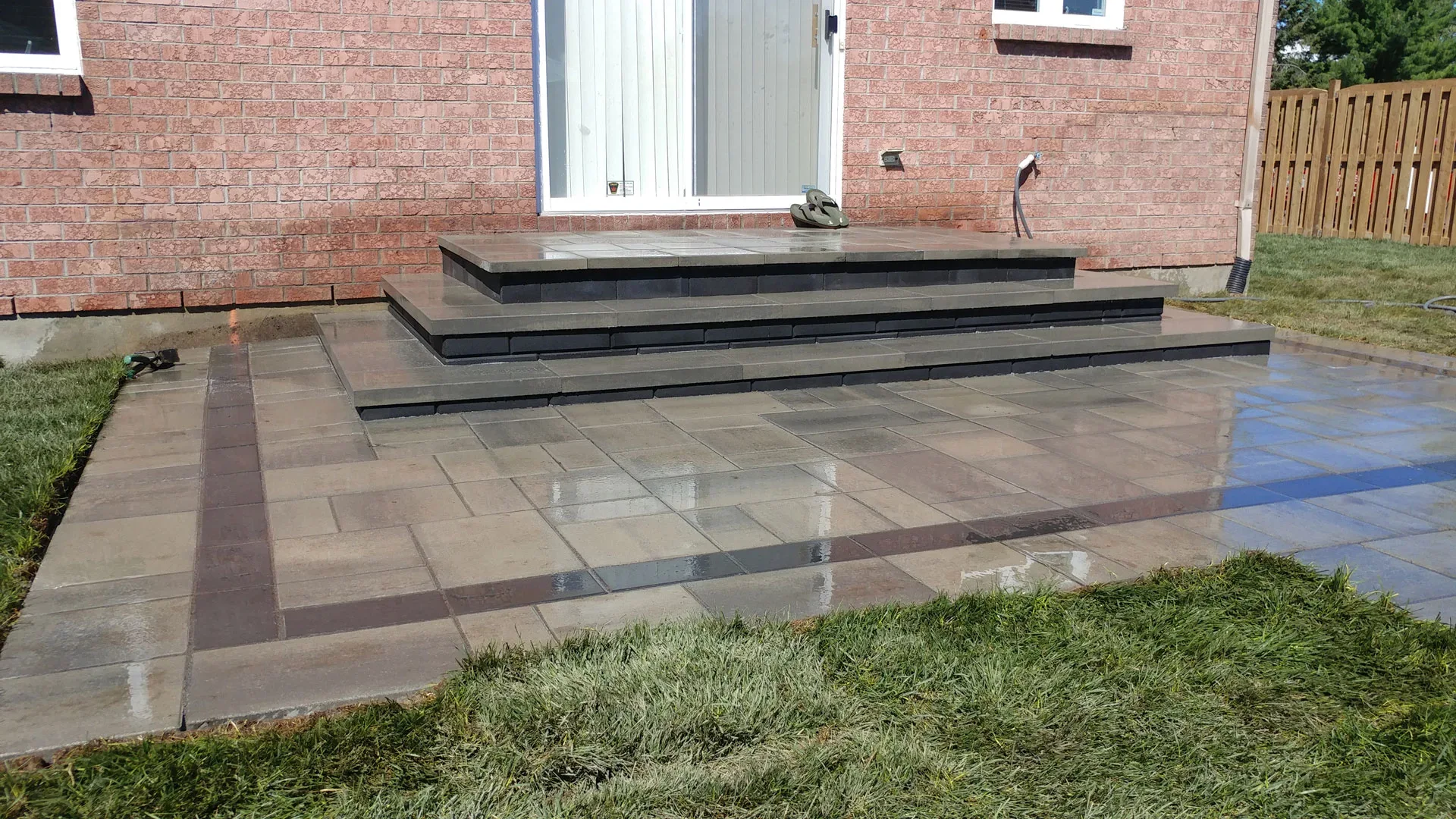 Paved entrance and wide steps at a brick house