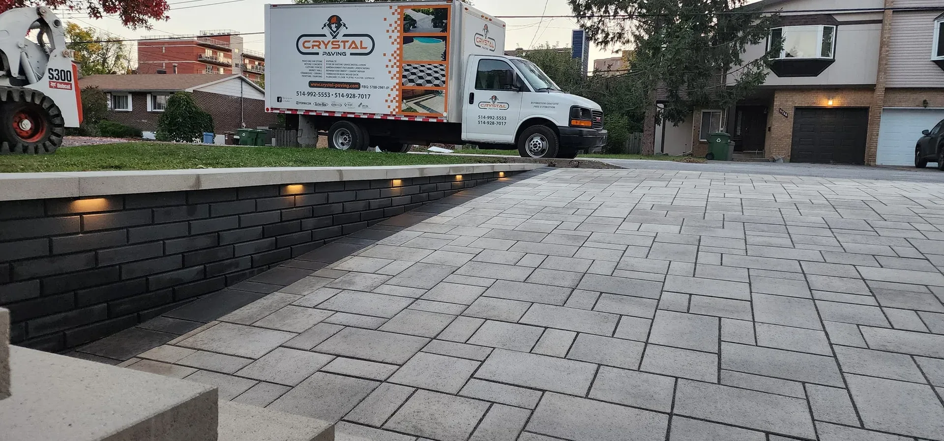 Interlocking driveway beside a low masonry wall